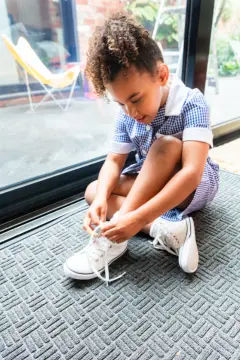 kiddo child tying laces