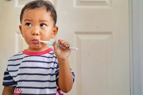 child brushing teeth