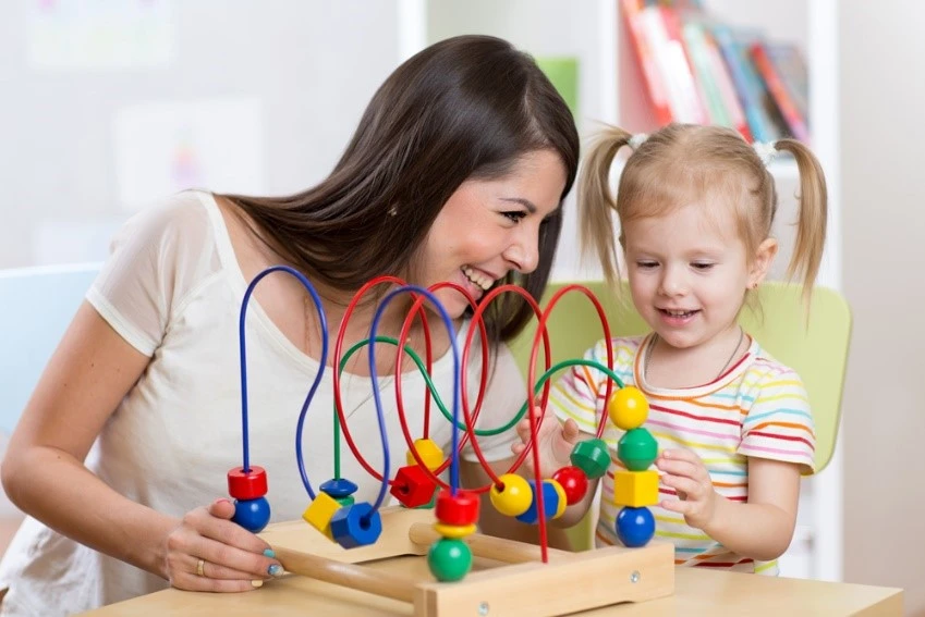 educator and child playing